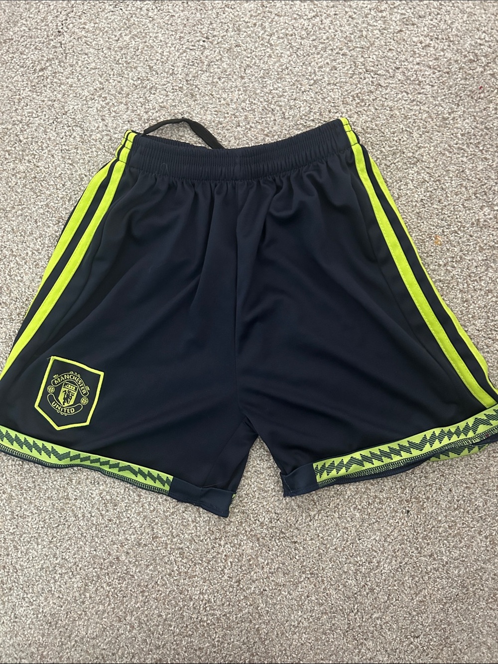 Manchester United Boy’s Black Soccer Shorts with Neon Yellow Trim